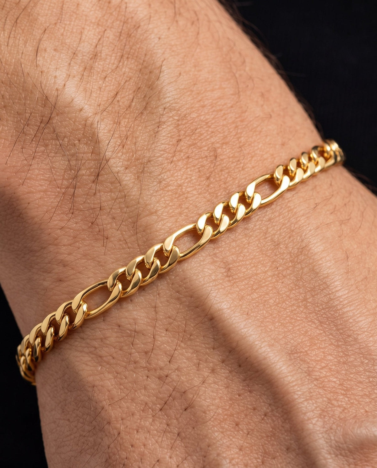 3mm gold Clean Figaro bracelet worn on the wrist